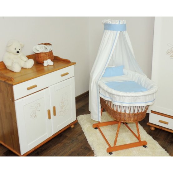 Wicker cot with blue set bedding